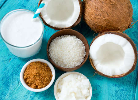 coconut sugar, milk and oil on wooden surface