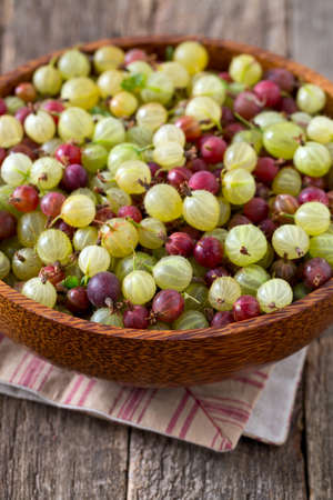gooseberries on wooden surfaceの写真素材