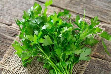 bunch of parsley on wooden surfaceの写真素材