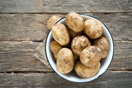 potatoes on wooden surfaceの写真素材