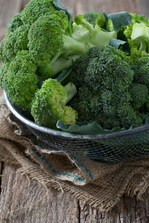 fresh broccoli on wooden surfaceの写真素材
