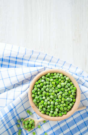frozem peas on wooden surfaceの写真素材