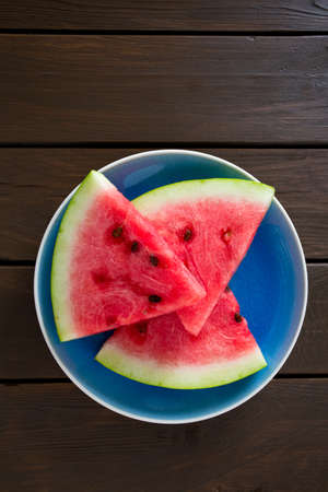 freshly cut water melon on wooden tableの写真素材