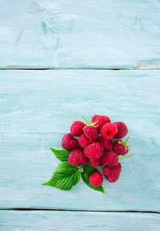 raspberries on wooden surface