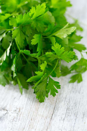 bunch of parsley on wooden surface