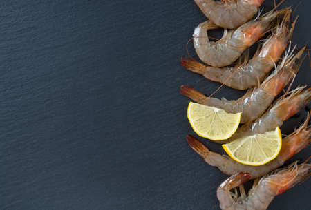 resh raw prawns on dark gray kitchen tableの写真素材