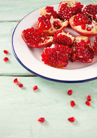 pomegranate seeds on wooden surfaceの写真素材