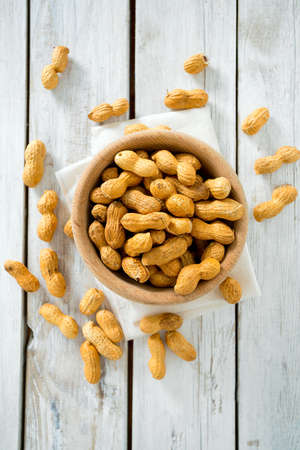 peanuts on wooden surface