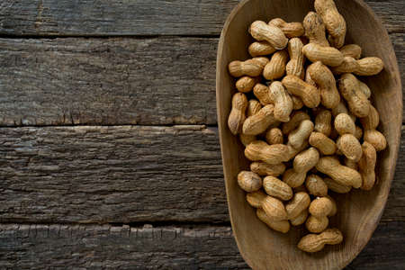peanuts on wooden surface