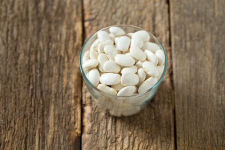 white butter beans on wooden surface