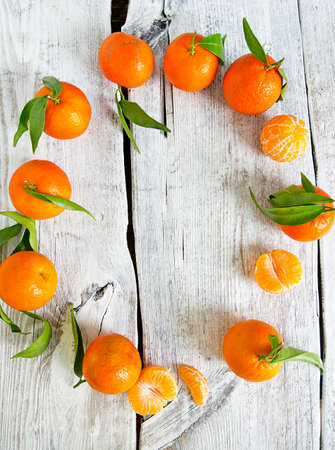 tangerines with green leaves on turquoise wooden backgroundの写真素材
