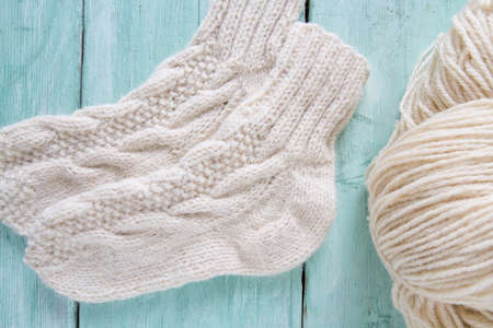 knitted socks and yarn on wooden surfaceの写真素材