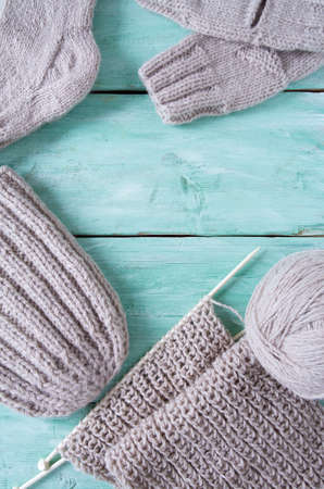 knitted clothes on turquoise wooden backgroundの写真素材