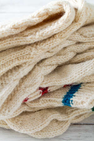 knitted clothes on turquoise wooden background