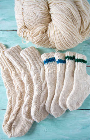 knitted socks and yarn on wooden surfaceの写真素材