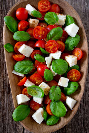 caprese salad on dark wooden surfaceの写真素材