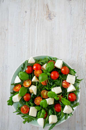 Vegetarian salad with cherry tomato, mozzarella and rucola