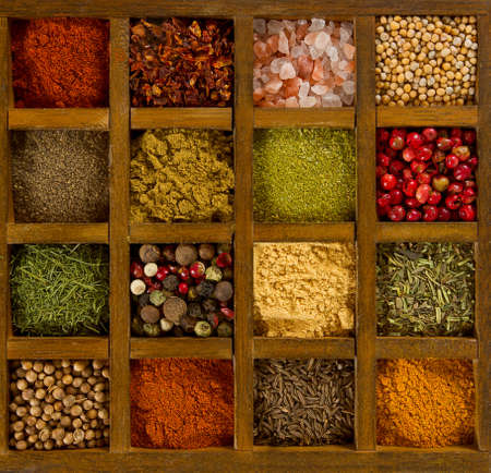 assortment of spices in wooden boxの写真素材