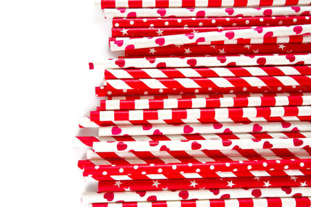 red paper straws on white background