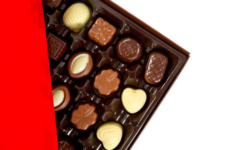 assorted chocolates in a box isolated on whiteの写真素材
