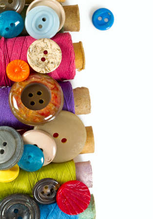 sewing buttons and thread isolated on white