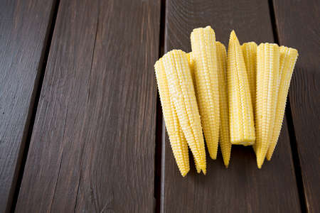 baby corn on wooden surfaceの写真素材