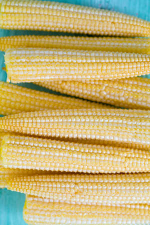 baby corn on wooden surfaceの写真素材