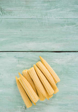 baby corn on wooden surfaceの写真素材
