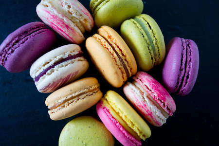 assorted macaroons on black chalkboard