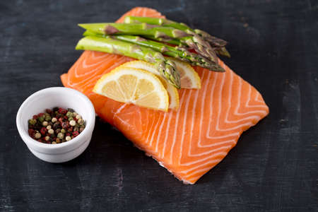 salmon fillet, lemon, asparagus and spicesの写真素材