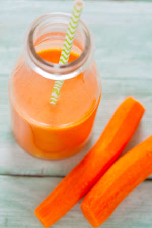 carrot juice on turquoise wooden backgroundの写真素材