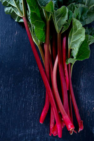 fresh rhubarb on wooden surfaceの写真素材