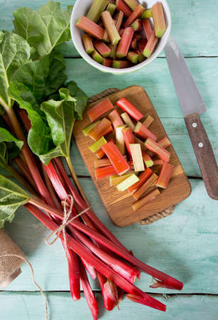pieces of rhubarb on turquoise wooden surfaceの写真素材