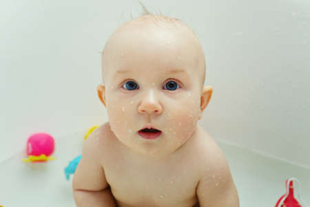 cute baby playing toys in bathtubeの写真素材