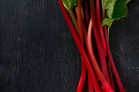 fresh rhubarb on wooden surfaceの写真素材
