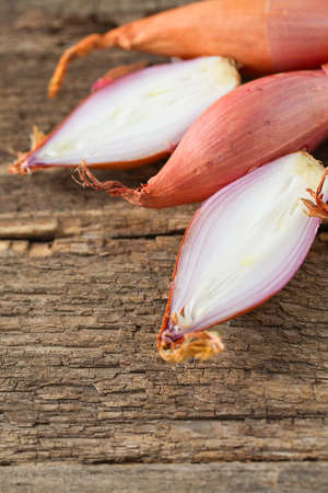 shallot onions on wooden surfaceの写真素材