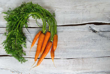 fresh carrots on wooden surfaceの写真素材