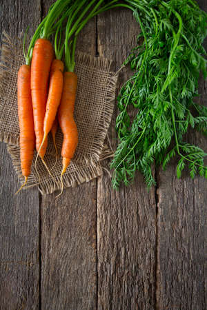 fresh carrots on wooden surfaceの写真素材
