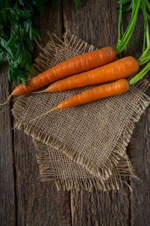 fresh carrots on wooden surfaceの写真素材