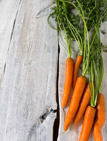 fresh carrots on wooden surfaceの写真素材