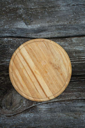 round cutting board on wooden surfaceの写真素材