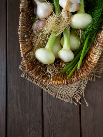 fresh onion and garlic on wooden surfaceの写真素材