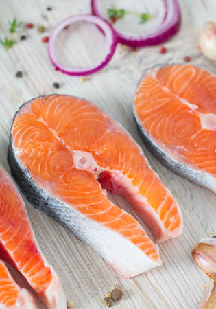 freshly cut raw salmon with spices on wooden surfaceの写真素材