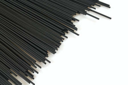 black spaghetti isolated on whiteの写真素材