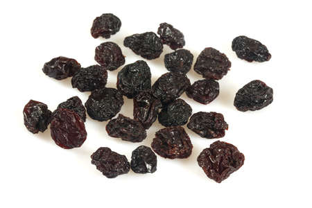 black raisins isolated on whiteの写真素材