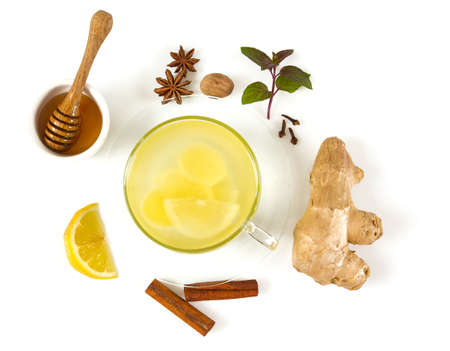 fresh tea with honey and spices isolated on white