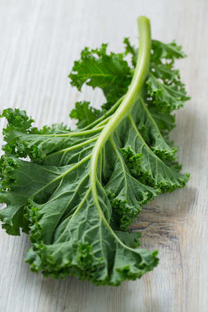 kale on white wooden surface