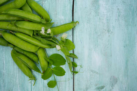 pea pods on wooden surfaceの写真素材