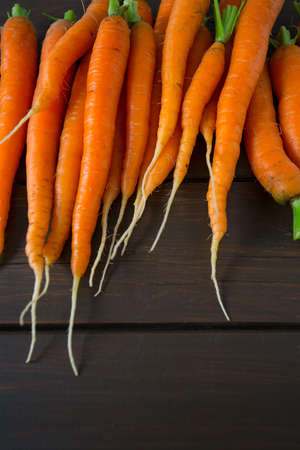 fresh carrots on wooden surfaceの写真素材