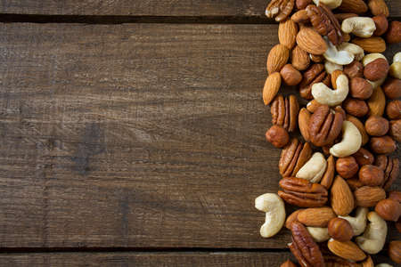 mixed nuts on wooden surface